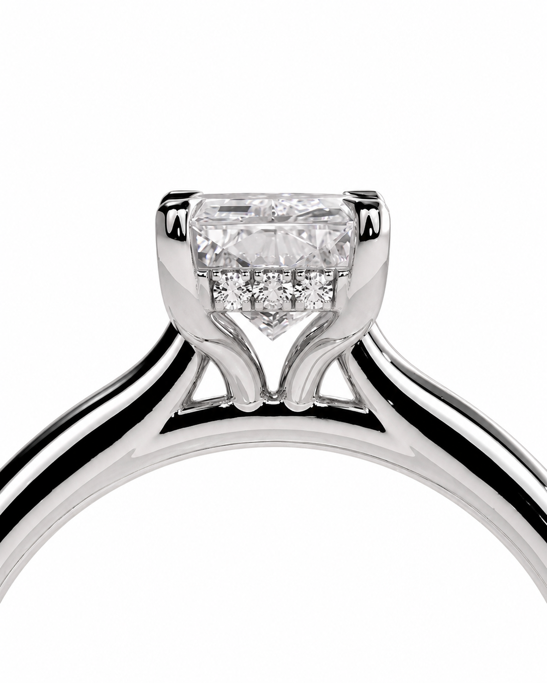 color_925_SIL,color_935_ARG,color_10K_WG, color_14K_WG &&A close-up studio shot of a silver-toned diamond ring featuring a rectangular emerald-cut center stone and smaller side stones in a prong setting, shown against a plain white background.