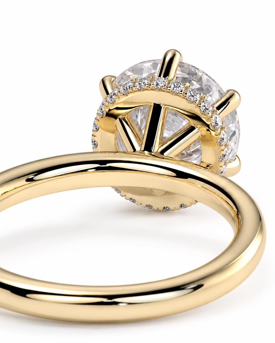 color_10K_YG, color_14K_YG &&A close-up shot of a yellow gold ring with a large round clear gemstone in a prong setting, surrounded by a halo of smaller accent diamonds on a white background.