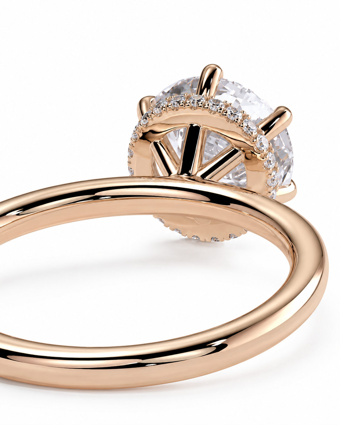 color_10K_RG, color_14K_RG &&Rose gold ring with a large round clear center stone and a halo of small clear stones, shown on a clean white background.