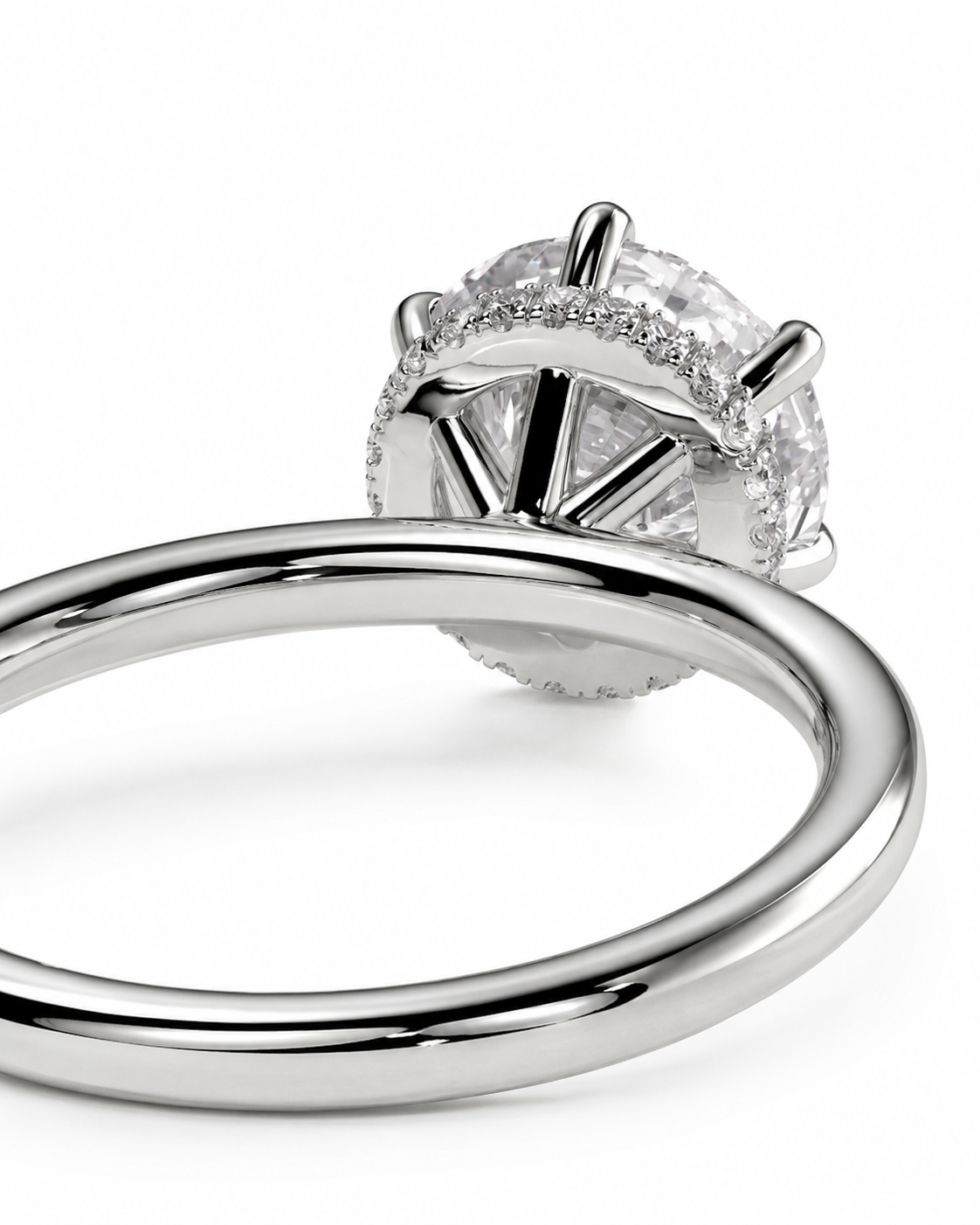 color_925_SIL,color_935_ARG,color_10K_WG, color_14K_WG &&A close-up studio shot of a silver-toned ring with a large clear gemstone in a prong setting, surrounded by a halo of smaller stones, on a white background.