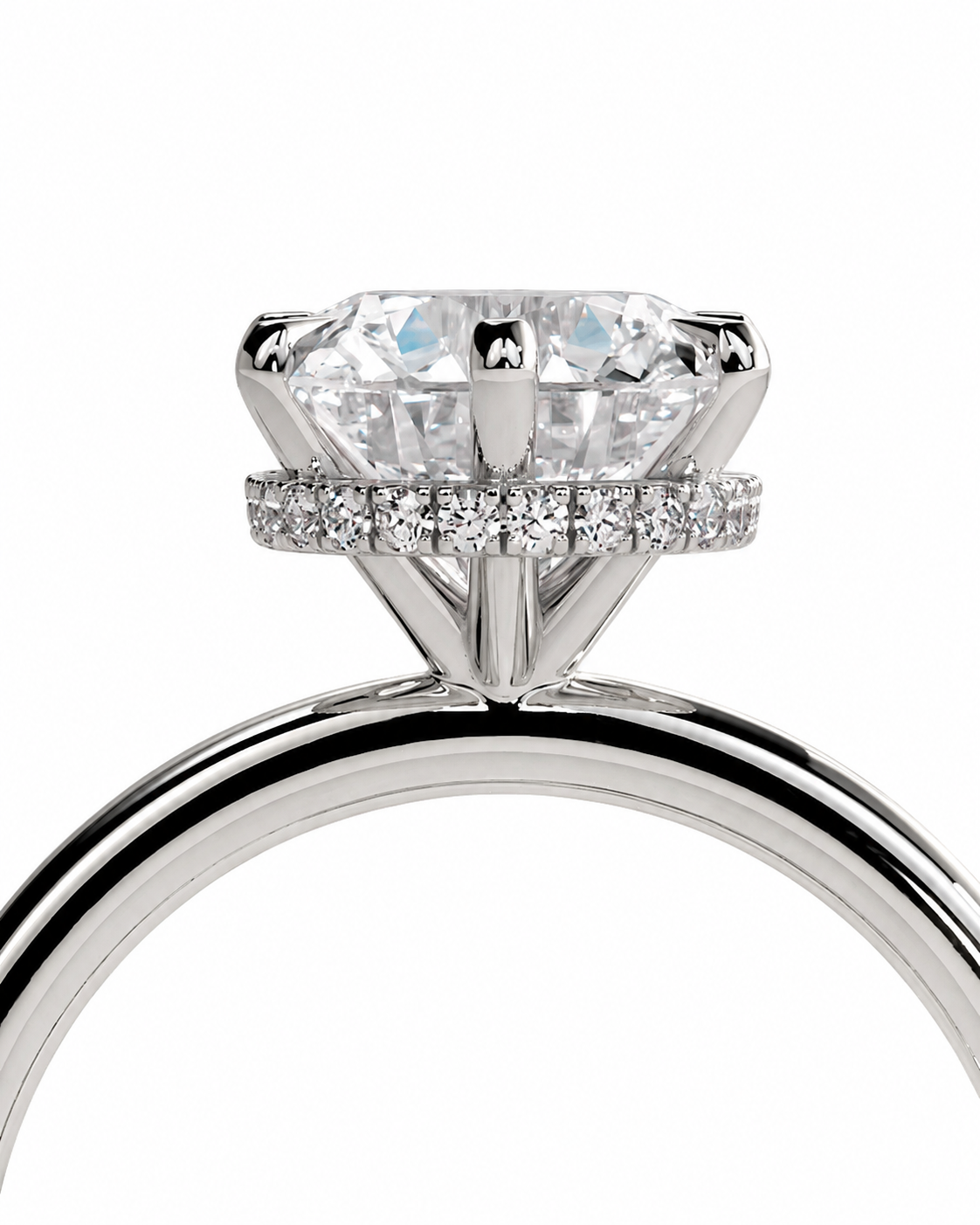 color_925_SIL,color_935_ARG,color_10K_WG, color_14K_WG &&A close-up studio shot of a diamond engagement ring featuring a large round-cut center stone in a four-prong setting, with a halo of small diamonds around the band, shown on a white background.