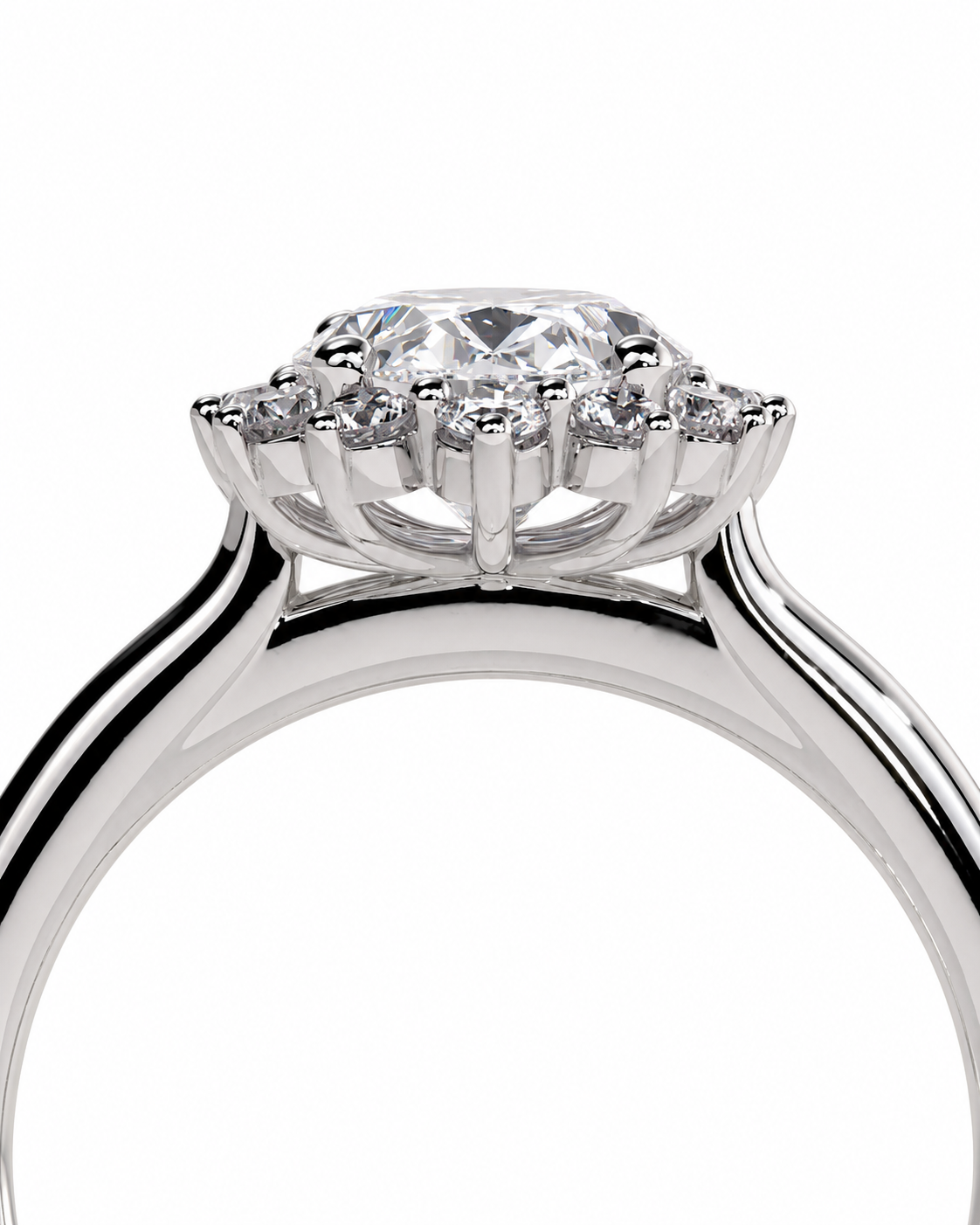color_925_SIL,color_935_ARG,color_10K_WG, color_14K_WG &&A close-up studio shot of a silver-toned diamond ring featuring a round-cut center stone surrounded by a halo of smaller diamonds, set against a plain white background.