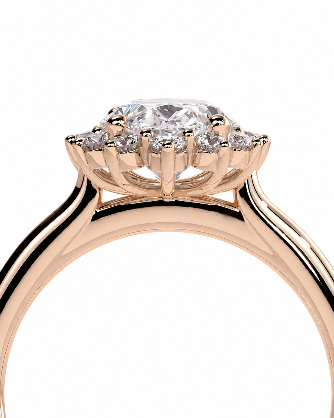 color_10K_RG, color_14K_RG &&A close-up of a rose gold halo engagement ring featuring a round center stone and smaller side stones, set against a plain white background.
