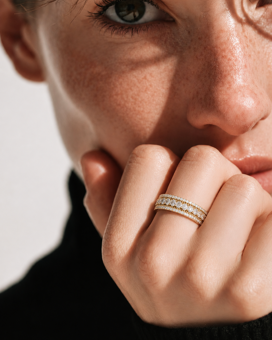 color_10K_YG, color_14K_YG &&	
Front view of a full eternity moissanite wedding band with round center stones and pave borders.