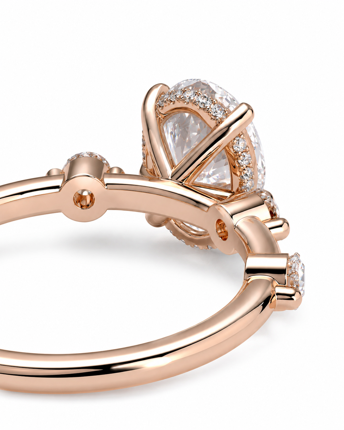 color_10K_RG, color_14K_RG &&Rose gold ring with a large oval clear gemstone and small accent stones, shown in a close-up studio shot on a white background.