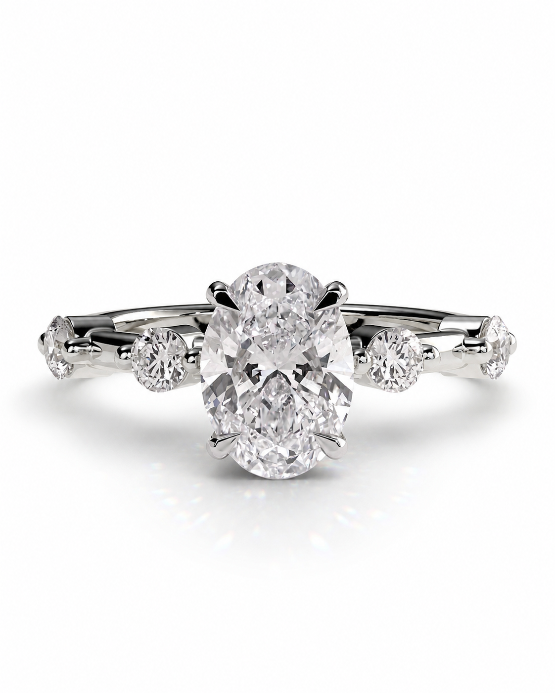 color_925_SIL,color_935_ARG,color_10K_WG, color_14K_WG &&An oval-cut diamond solitaire engagement ring with a diamond-accented shank, set in a silver-colored metal on a clean white background.