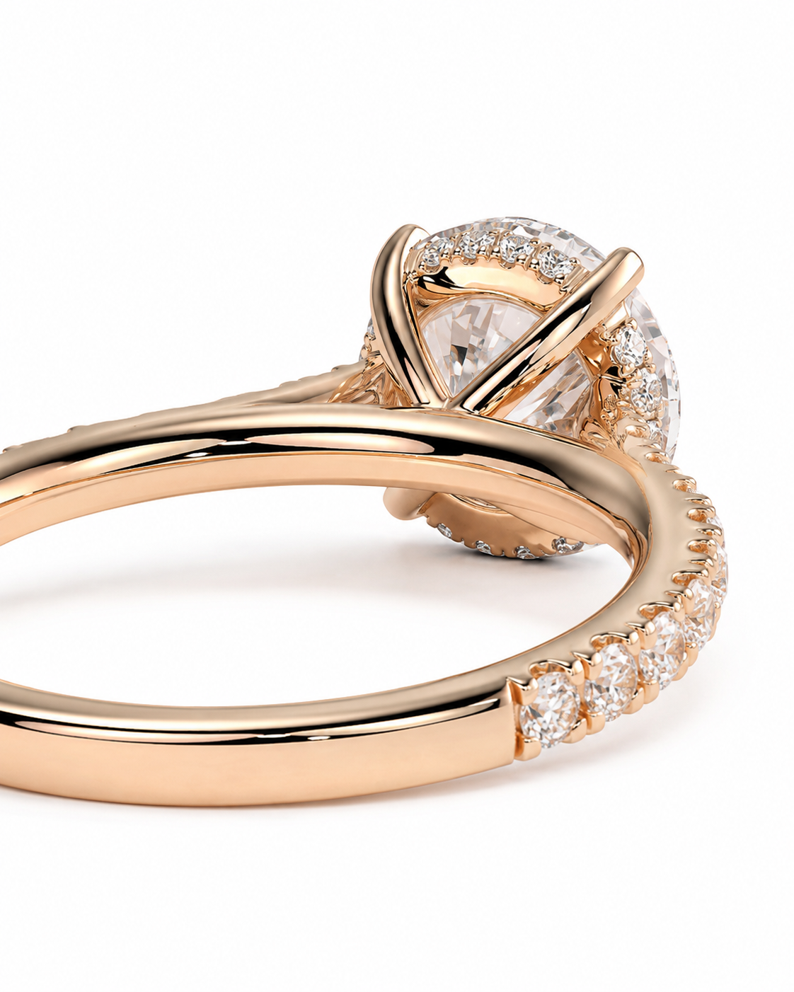 color_10K_RG, color_14K_RG &&A close-up of a rose gold ring featuring a marquise-cut center stone surrounded by a halo of small clear stones, with additional pave stones along the band, set against a clean white background.