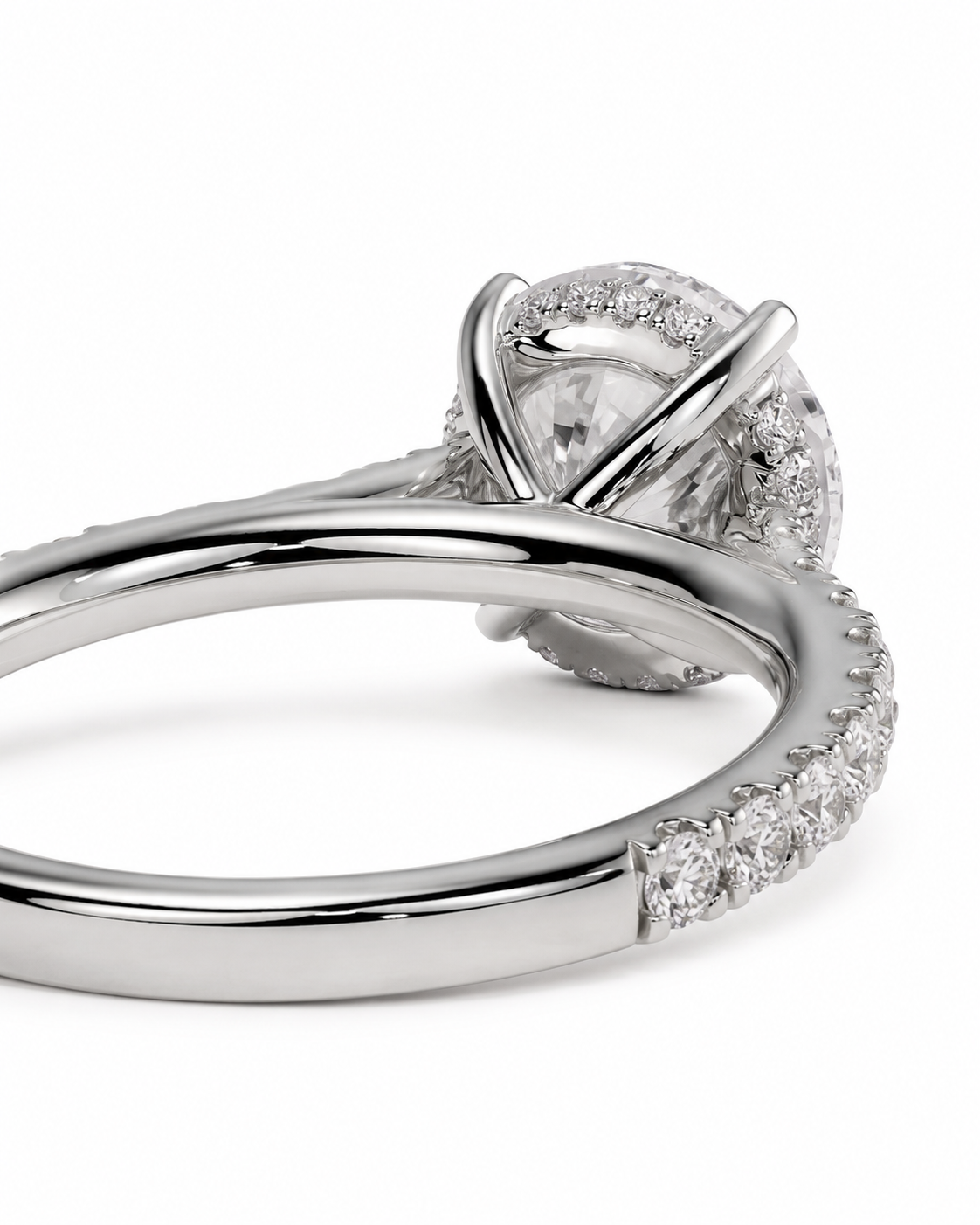 color_925_SIL,color_935_ARG,color_10K_WG, color_14K_WG &&A close-up studio shot of a silver-toned ring featuring a large clear center stone surrounded by a halo of small pave-set stones, with additional stones along the band, on a white background.