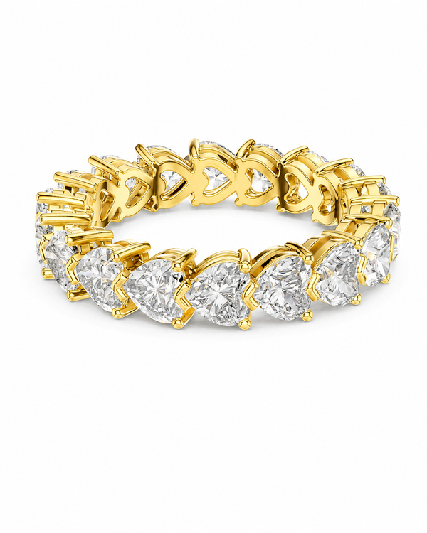 color_10K_YG, color_14K_YG &&	
A yellow gold eternity ring featuring a continuous row of heart-shaped clear gemstones in a prong setting, shown on a plain white background.