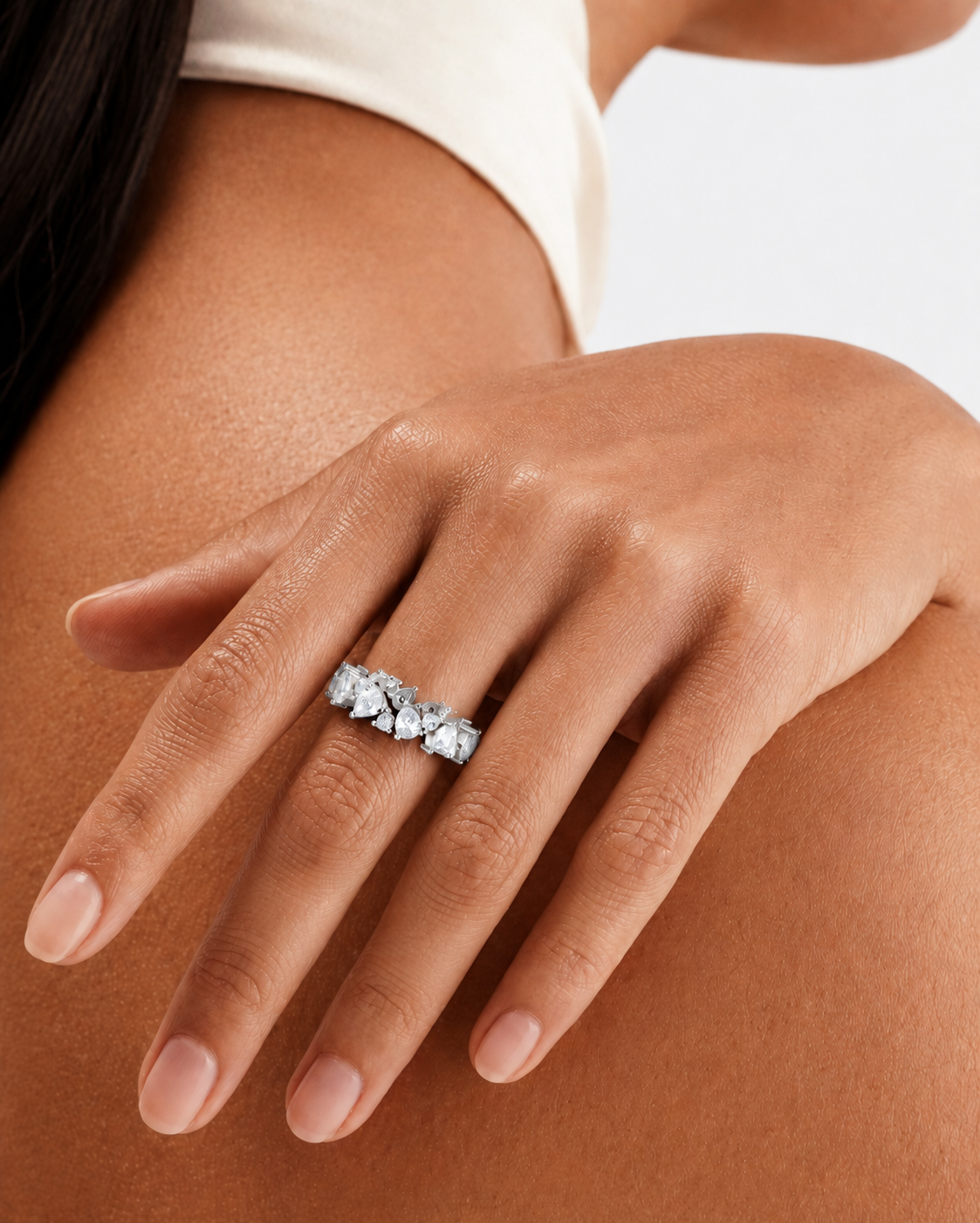 color_925_SIL,color_935_ARG,color_10K_WG, color_14K_WG &&	
A close-up of a woman's hand wearing a silver-toned ring set with multiple marquise-cut clear gemstones, shown against her skin and a white top.