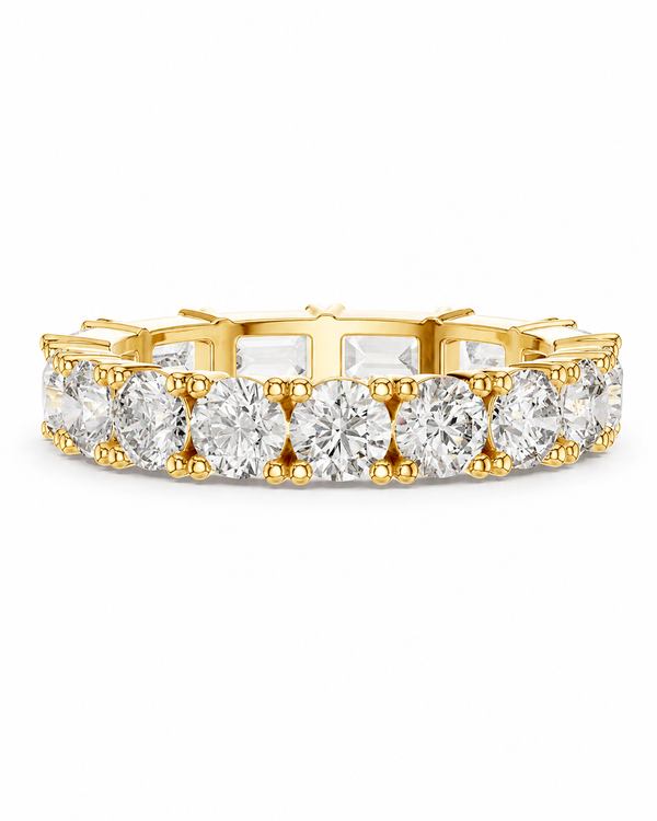 color_10K_YG, color_14K_YG &&	
A yellow gold eternity ring featuring a continuous row of round brilliant-cut diamonds and baguette-cut diamonds, set in a prong setting against a solid white background.