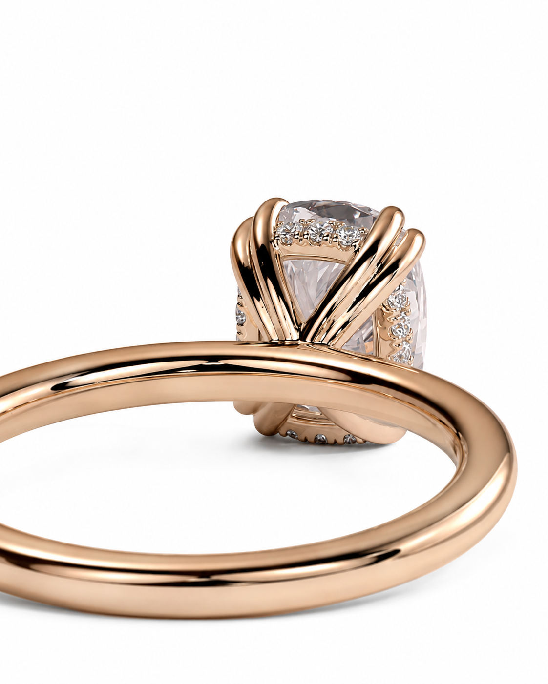 color_10K_RG, color_14K_RG &&A close-up of a rose gold ring featuring a large cushion-cut clear gemstone in a twisted wrap setting, accented with small pave diamonds, on a white background.
