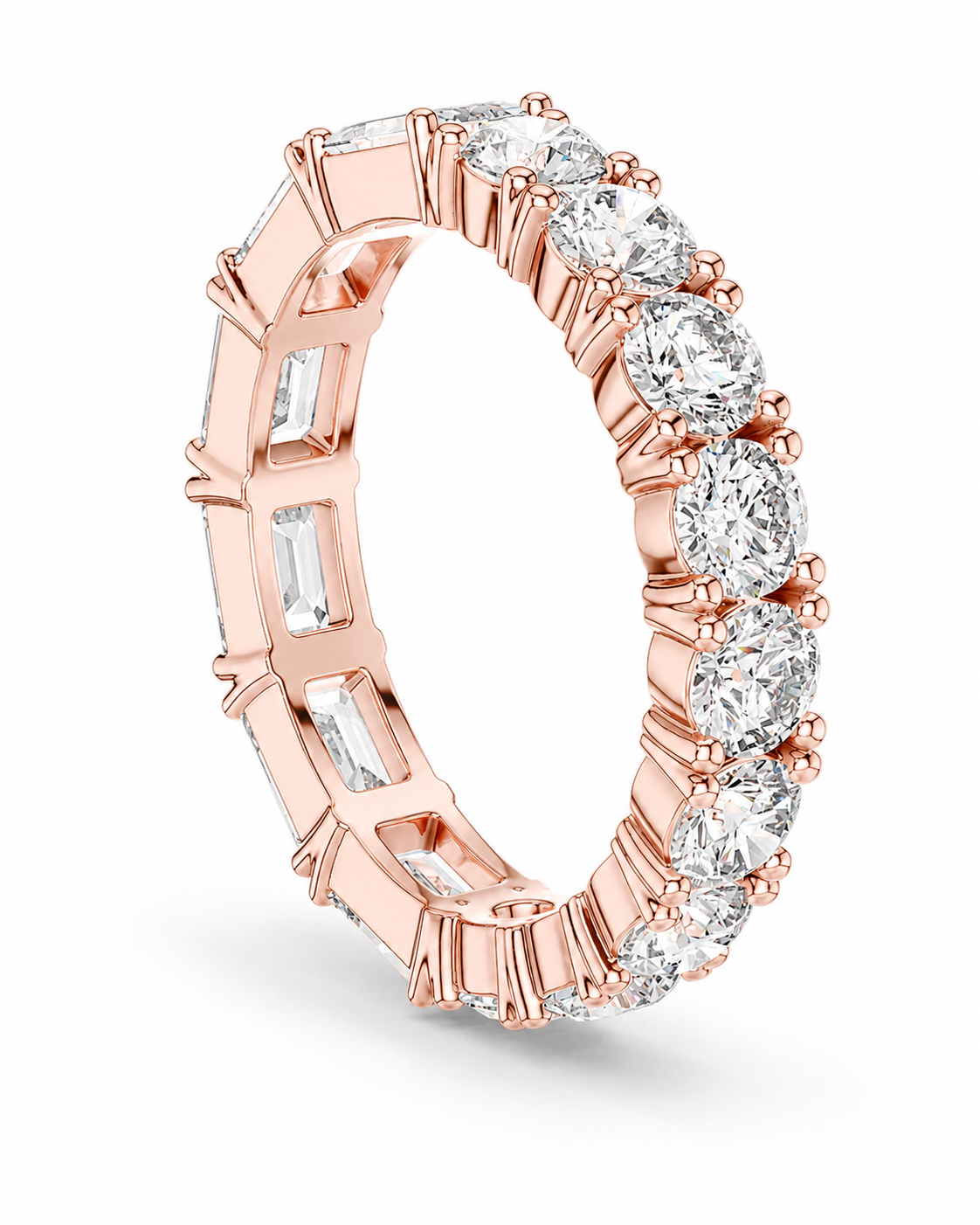 color_10K_RG, color_14K_RG &&	A rose gold eternity ring featuring a continuous row of clear gemstones, including round brilliant-cut and baguette-cut stones, set in a polished rose gold band on a white background.