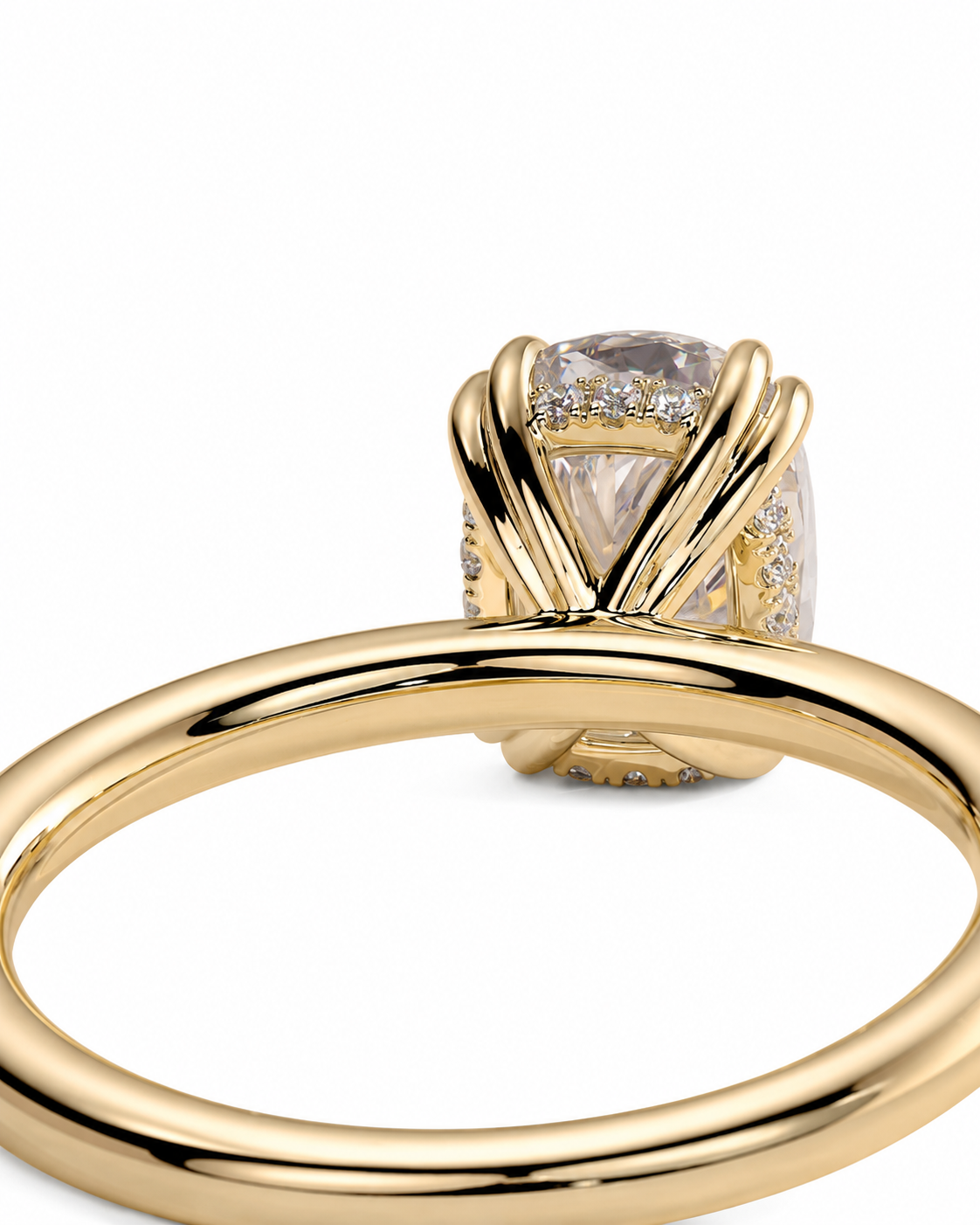 color_10K_YG, color_14K_YG &&A close-up of a yellow gold ring with a large cushion-cut clear gemstone in a wrap-style setting, accented with small pave diamonds, on a white background.