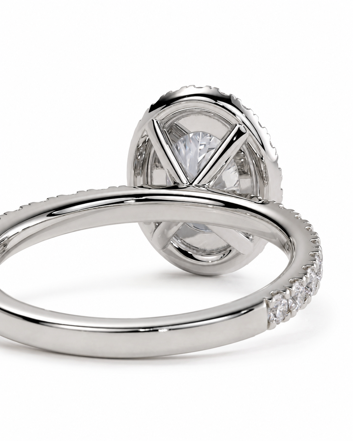 color_925_SIL,color_935_ARG,color_10K_WG, color_14K_WG &&A close-up studio shot of a silver-toned ring with a large oval clear gemstone in a prong setting, with small clear stones along the band, on a white background.