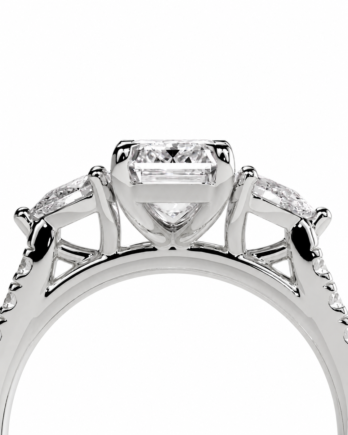 color_925_SIL,color_935_ARG,color_10K_WG, color_14K_WG &&A close-up studio shot of a silver-toned diamond ring featuring a central baguette-cut diamond in a prong setting with smaller side diamonds, shown against a plain white background.