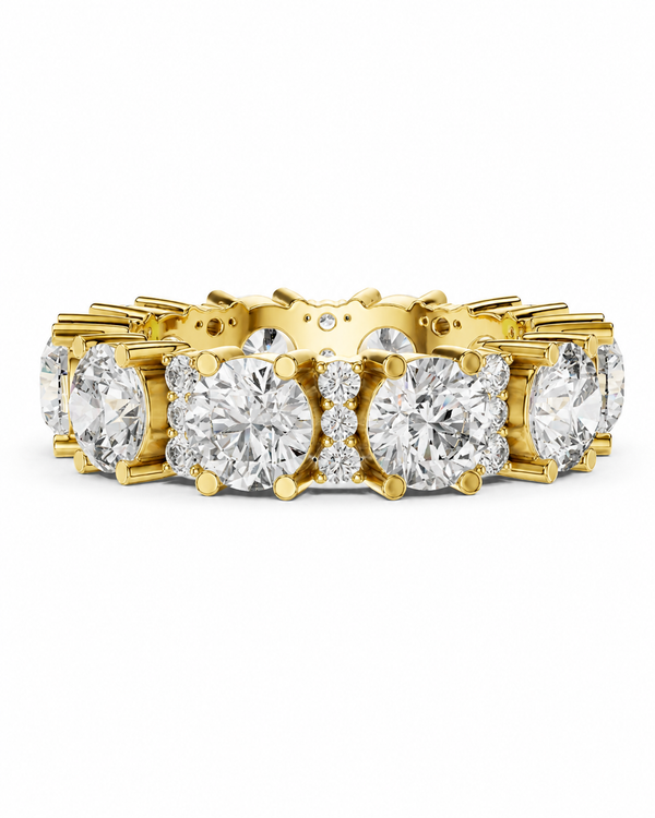 color_10K_YG, color_14K_YG &&	
A yellow gold eternity ring featuring a continuous row of round brilliant-cut diamonds and small accent diamonds in a prong setting, shown against a plain white background.