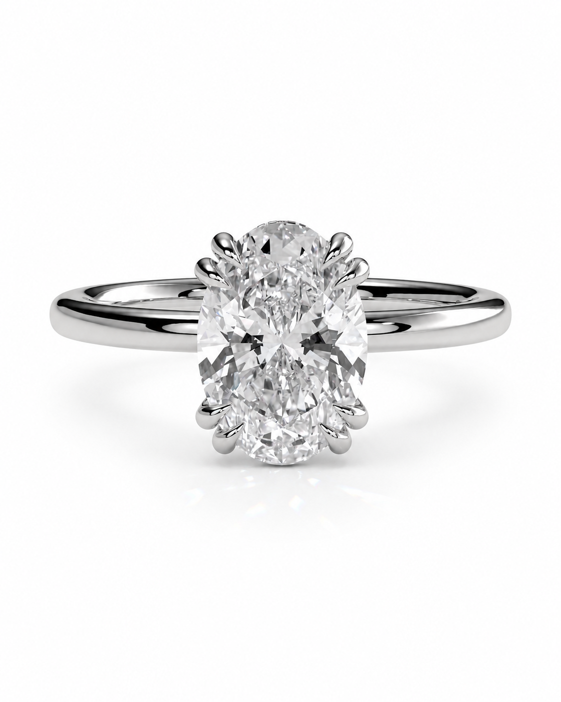 color_925_SIL,color_935_ARG,color_10K_WG, color_14K_WG &&An oval diamond engagement ring with a brilliant round-cut center stone in a four-prong setting on a polished silver-colored band, shown against a plain white background.