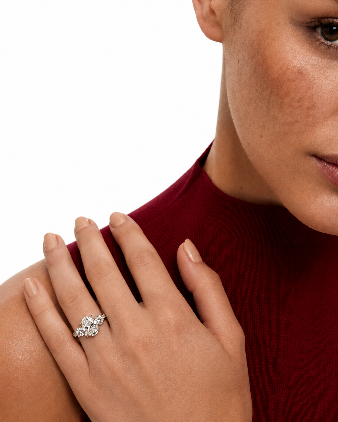 color_925_SIL,color_935_ARG,color_10K_WG, color_14K_WG &&A close-up lifestyle shot of a woman wearing a silver-toned diamond ring on her ring finger, with her hand resting on her shoulder against a white background.