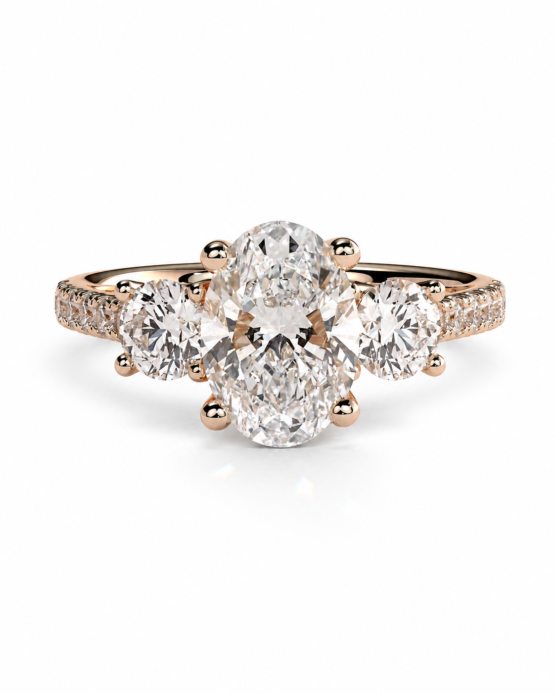 color_10K_RG, color_14K_RG &&A rose gold cluster engagement ring featuring a large oval center stone flanked by two round side stones, with pave-set accent stones along the band, shown on a clean white background.
