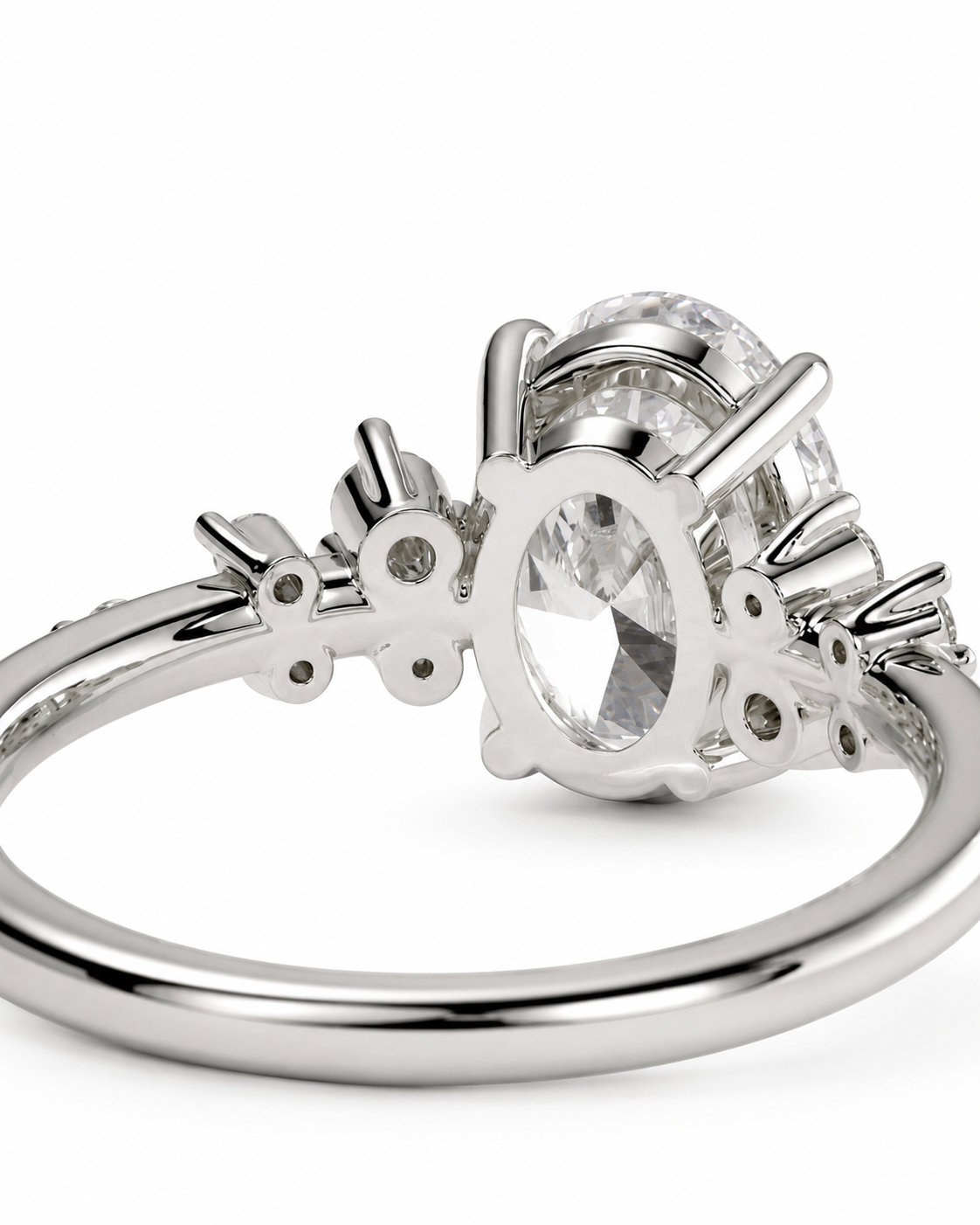 color_925_SIL,color_935_ARG,color_10K_WG, color_14K_WG &&A silver-toned ring featuring a large oval clear gemstone in a prong setting, with smaller accent stones along the band, shown on a clean white background.