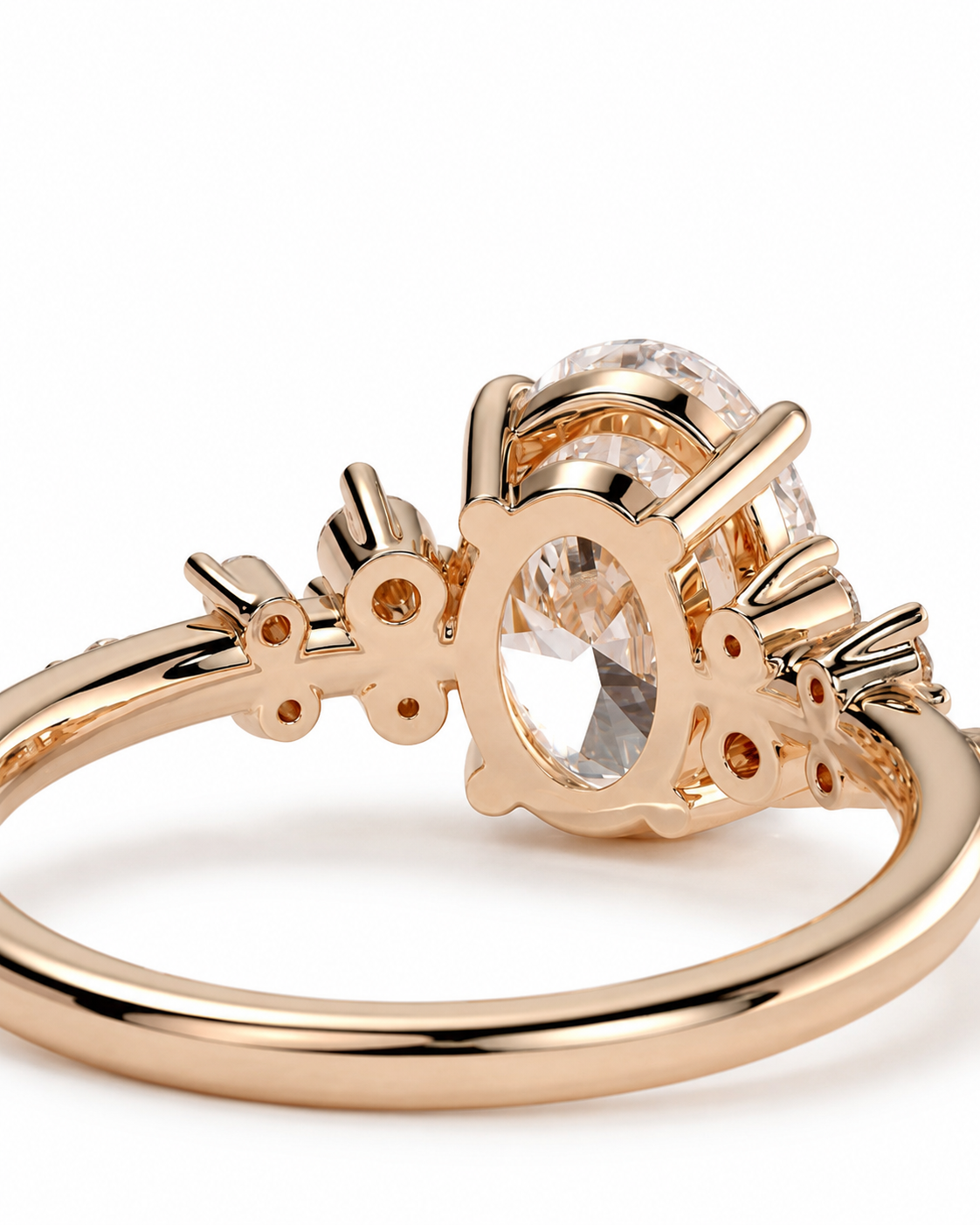 color_10K_RG, color_14K_RG &&A close-up of a rose gold ring featuring a large oval clear gemstone in a decorative setting with small accent stones, shown on a white background.