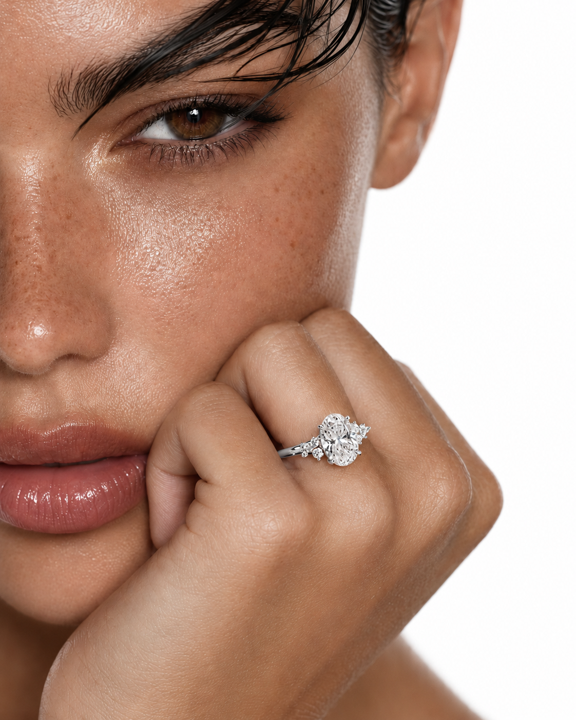 color_925_SIL,color_935_ARG,color_10K_WG, color_14K_WG &&A close-up lifestyle shot of a model wearing a silver-toned ring with a floral cluster of clear stones on her finger, set against a clean white background.