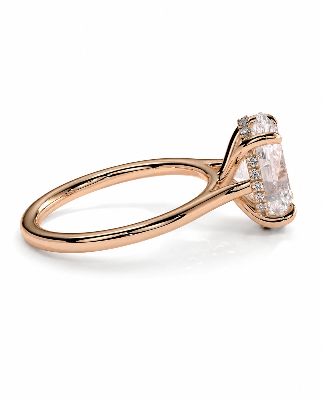 color_10K_RG, color_14K_RG &&A rose gold ring featuring a large rectangular clear gemstone in a prong setting, accented by small round stones along the side, shown on a clean white background.