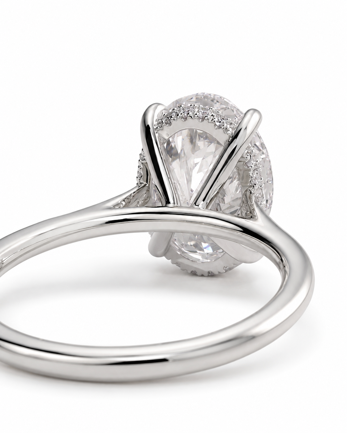 color_925_SIL,color_935_ARG,color_10K_WG, color_14K_WG &&A close-up shot of a silver-toned diamond ring with a marquise-cut center stone and a halo of smaller diamonds, set against a clean white background.