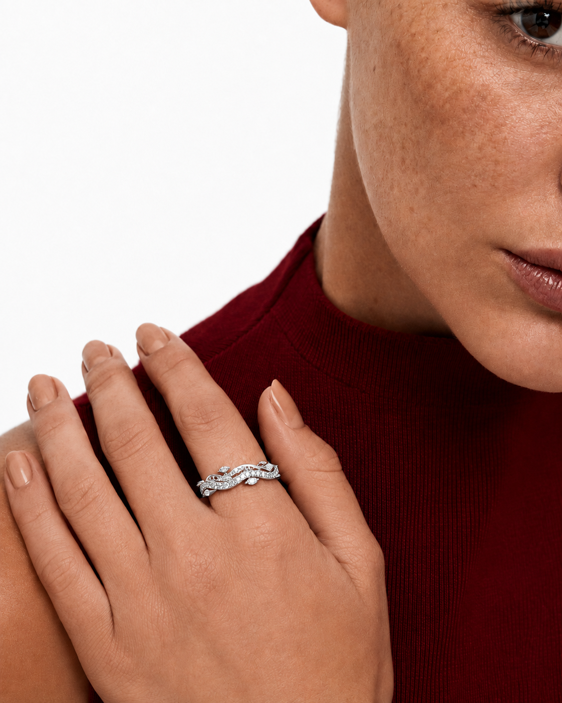 color_925_SIL,color_935_ARG,color_10K_WG, color_14K_WG &&	
A close-up lifestyle shot of a woman wearing a silver-toned wavy band ring with small clear stones, shown on her finger with her hand resting on her shoulder.