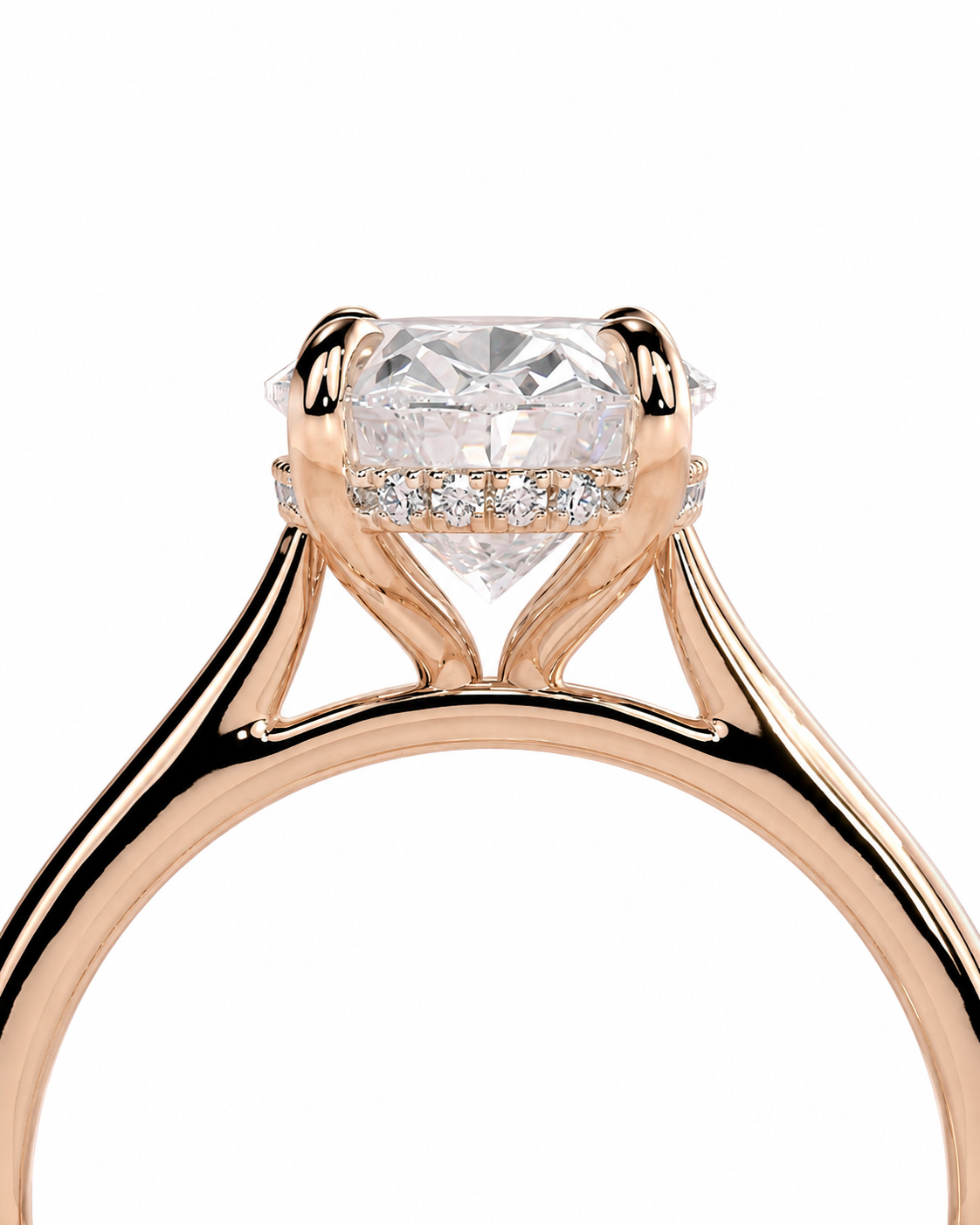 color_10K_RG, color_14K_RG &&A close-up of a rose gold solitaire engagement ring featuring a large round-cut diamond center stone and a halo of small pave diamonds, set against a plain white background.
