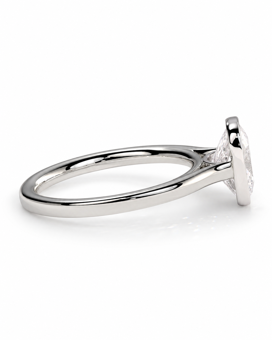 color_925_SIL,color_935_ARG,color_10K_WG, color_14K_WG &&A close-up side view of a polished silver-toned ring with a clear gemstone in a bezel setting, shown on a clean white background.