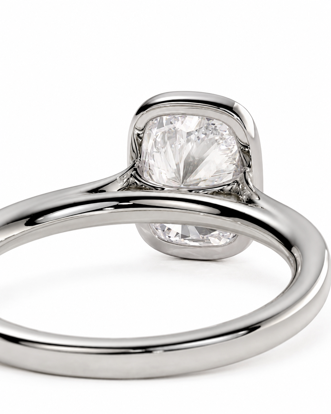 color_925_SIL,color_935_ARG,color_10K_WG, color_14K_WG &&A close-up shot of a silver-toned ring featuring a cushion-cut clear gemstone in a prong setting, on a clean white background.