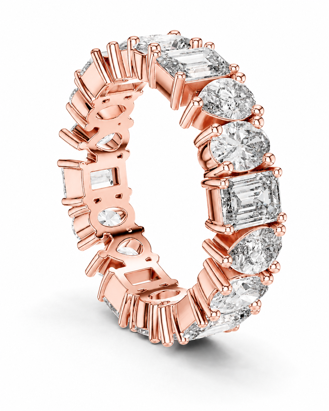 color_10K_RG, color_14K_RG &&	A rose gold eternity ring featuring multiple round and baguette-cut clear diamonds in a prong setting, shown on a clean white background.