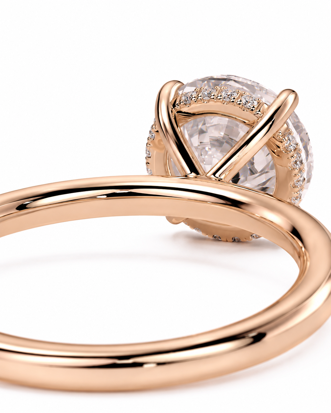 color_10K_RG, color_14K_RG &&Rose gold ring with a large clear round gemstone in a prong setting, accented with small pave stones, photographed on a white background.
