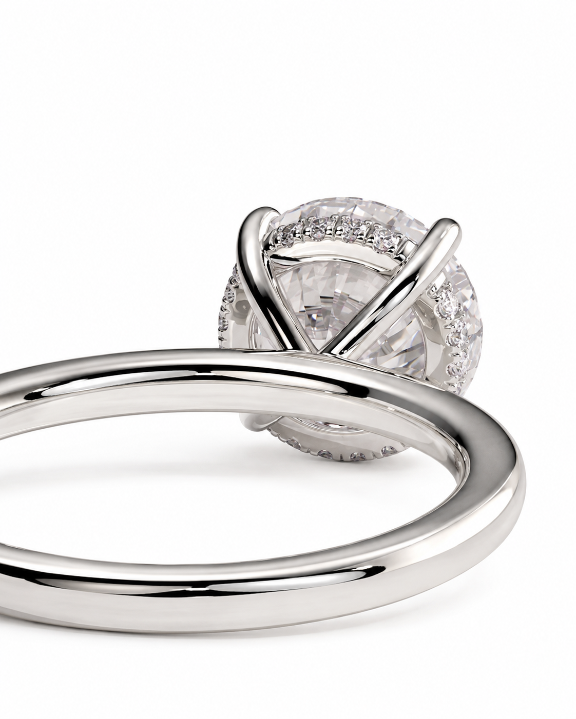 color_925_SIL,color_935_ARG,color_10K_WG, color_14K_WG &&A close-up studio shot of a silver-toned ring with a round clear gemstone in a prong setting, with a polished band running horizontally across the foreground on a white background.