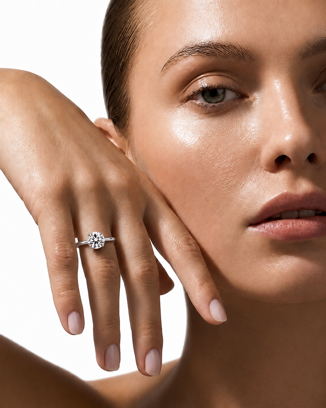 color_925_SIL,color_935_ARG,color_10K_WG, color_14K_WG &&A close-up of a woman's face and hand wearing a silver-toned diamond engagement ring on her ring finger, set against a clean white background.