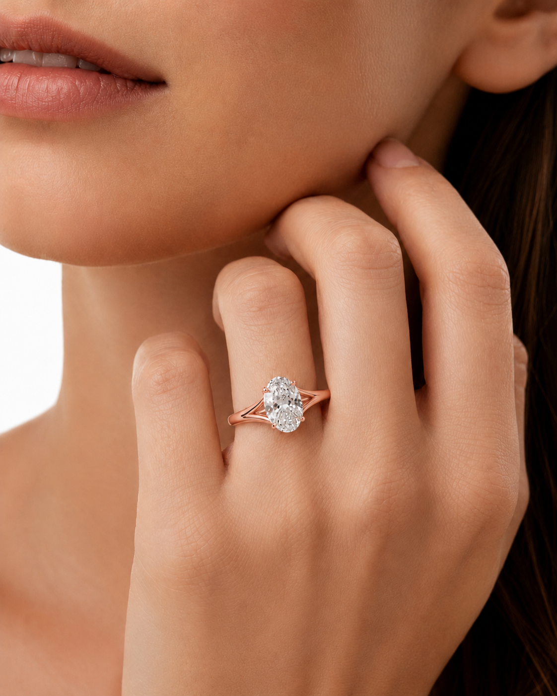 color_10K_RG, color_14K_RG &&A close-up lifestyle shot of a model wearing a rose gold ring with a round-cut clear gemstone on her finger.