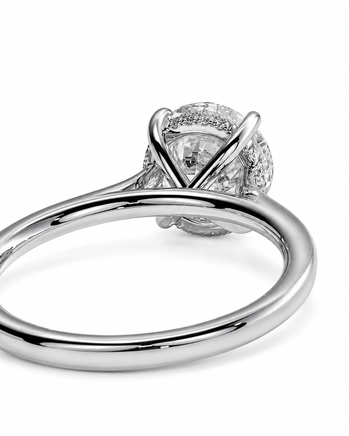 color_925_SIL,color_935_ARG,color_10K_WG, color_14K_WG &&A close-up shot of a silver-toned ring featuring a large round-cut center stone surrounded by a halo of smaller stones, with a split shank band, set against a plain white background.