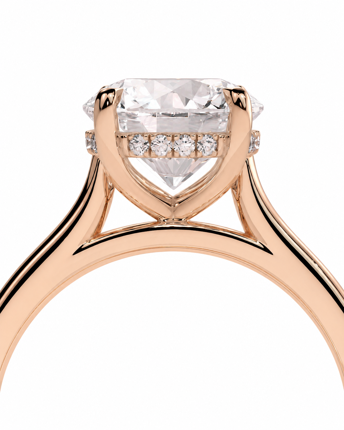 color_10K_RG, color_14K_RG &&Rose gold solitaire engagement ring with a large cushion-cut clear center stone and a row of small pave-set diamonds along the halo, shown on a white background.