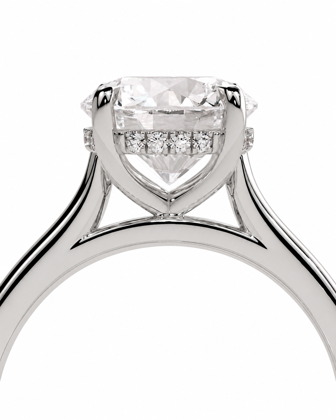 color_925_SIL,color_935_ARG,color_10K_WG, color_14K_WG &&A close-up studio shot of a diamond ring featuring a large round brilliant-cut center stone in a prong setting, with a row of smaller diamonds along the band, shown against a plain white background.