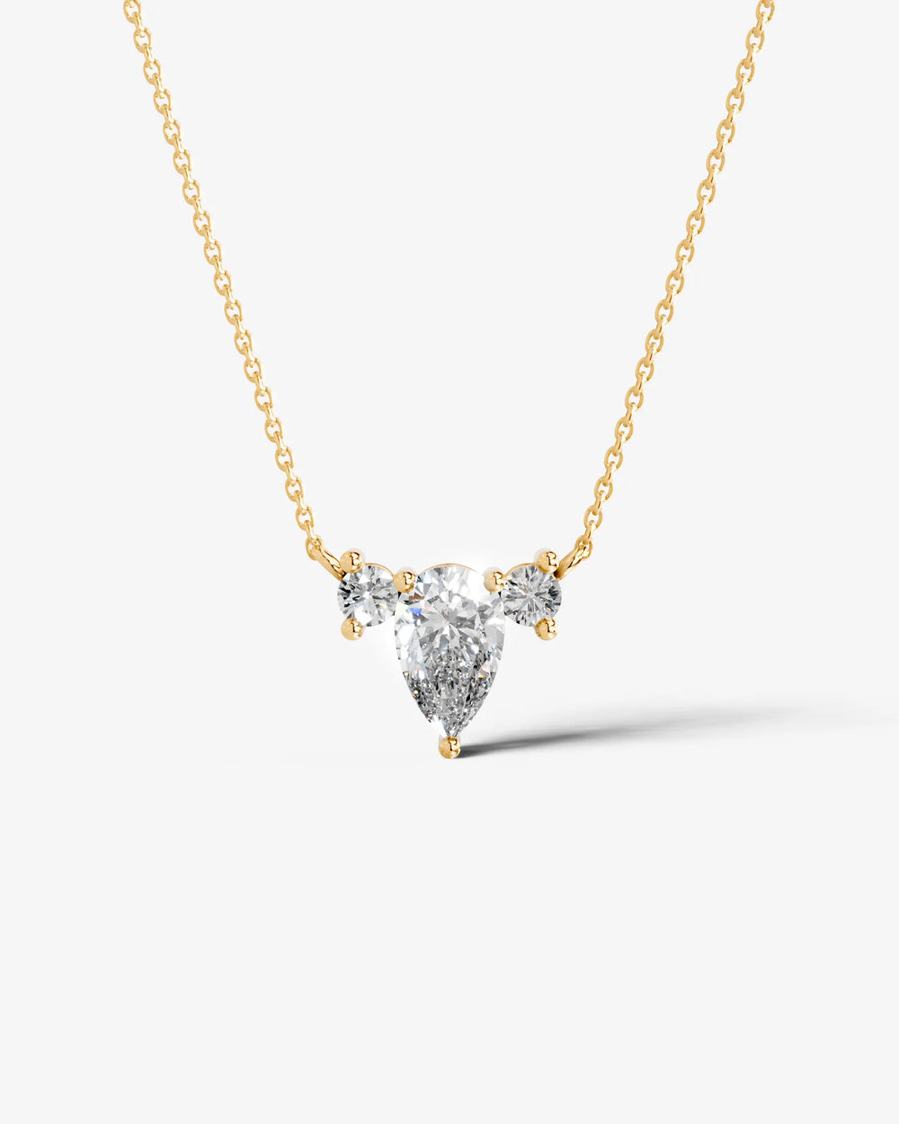 Pear Moissanite cluster pendant necklace featuring a pear-shaped center stone with two round accent stones in a front view.