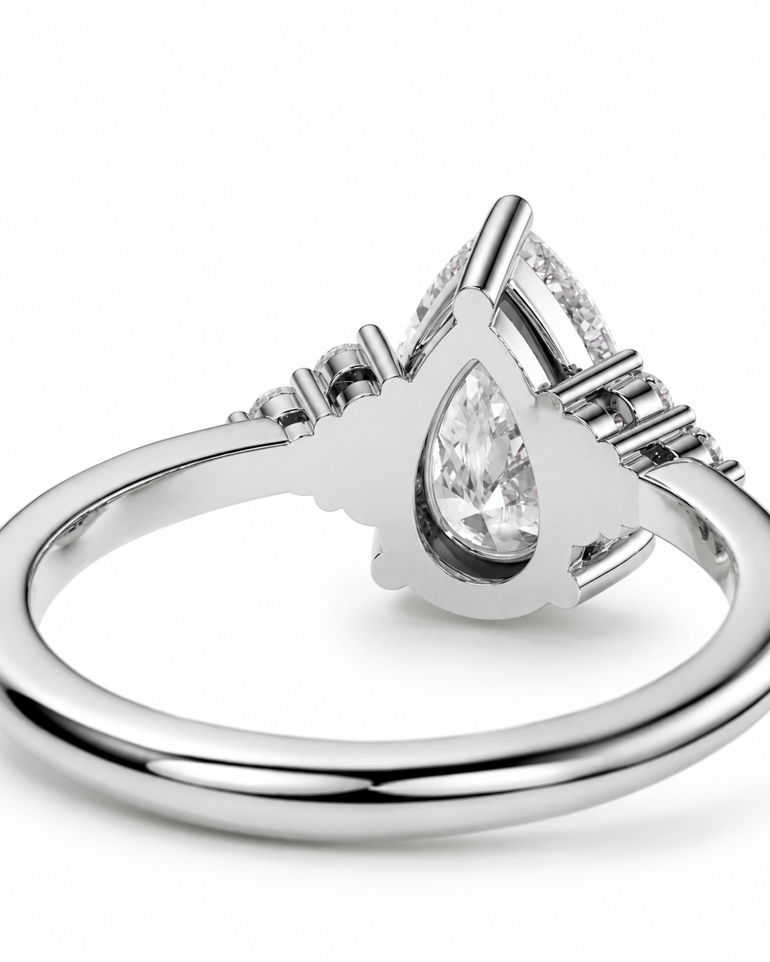 color_925_SIL,color_935_ARG,color_10K_WG, color_14K_WG &&A silver-toned ring featuring a central teardrop-shaped clear gemstone surrounded by smaller stones, shown on a clean white background.