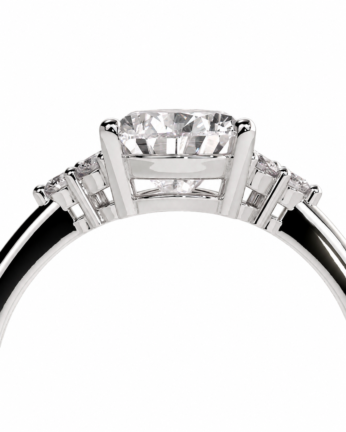 color_925_SIL,color_935_ARG,color_10K_WG, color_14K_WG &&A close-up studio shot of a silver-toned diamond ring, showing the top-down view of a large cushion-cut center stone with smaller diamonds on either side of the band, set against a plain white background.