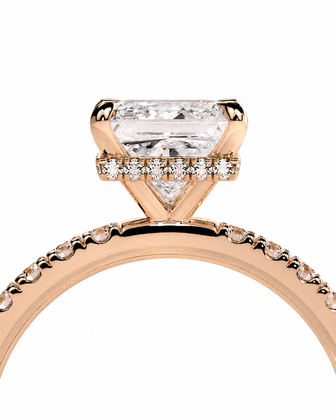 color_10K_RG, color_14K_RG &&A close-up of a rose gold engagement ring featuring a large triangular clear gemstone in a prong setting, with smaller accent diamonds along the band, shown against a plain white background.