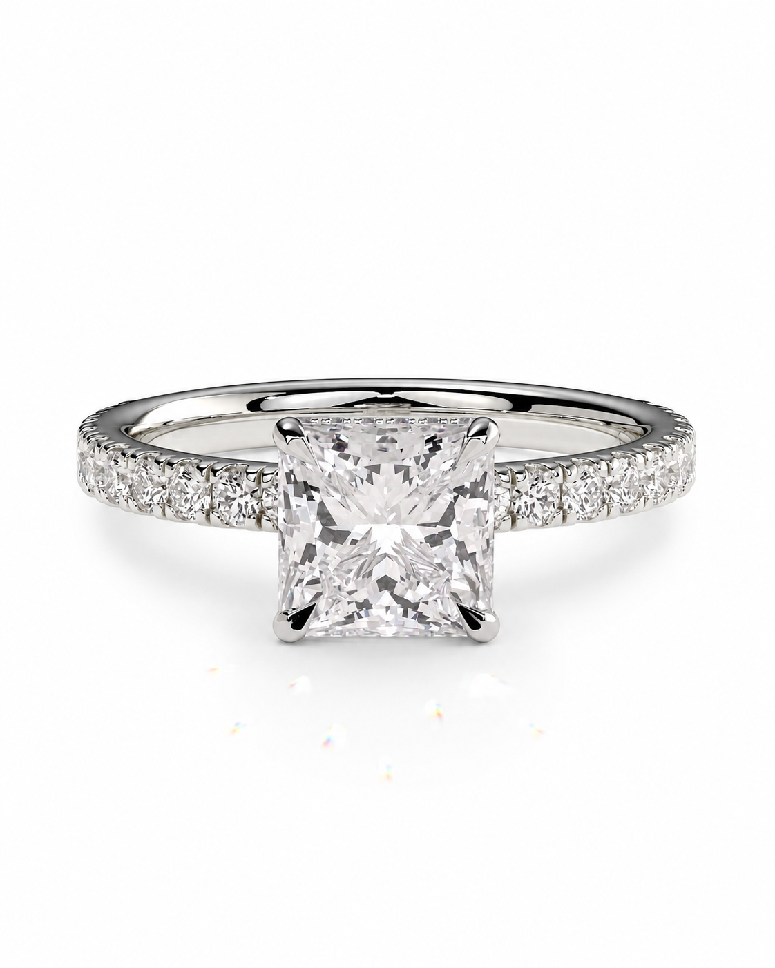 color_925_SIL,color_935_ARG,color_10K_WG, color_14K_WG &&A princess-cut diamond engagement ring with a radiant center stone and a pave-set diamond band in a silver-colored metal, shown on a clean white background.