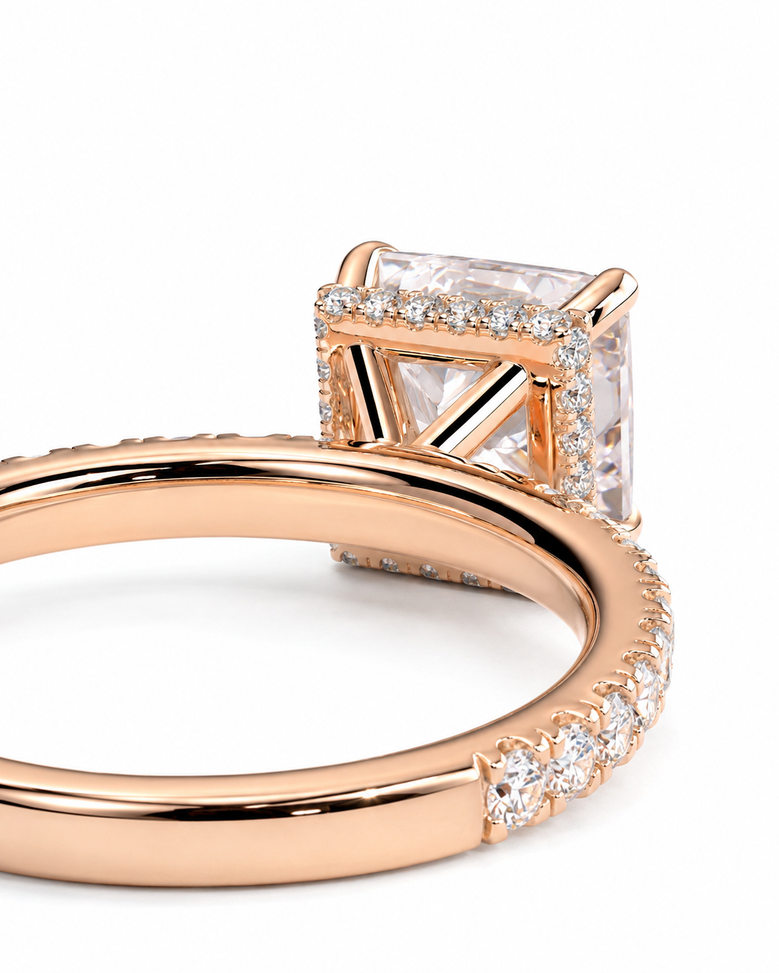 color_10K_RG, color_14K_RG &&Rose gold ring with a princess-cut clear gemstone and pave-set accent stones on a white background.