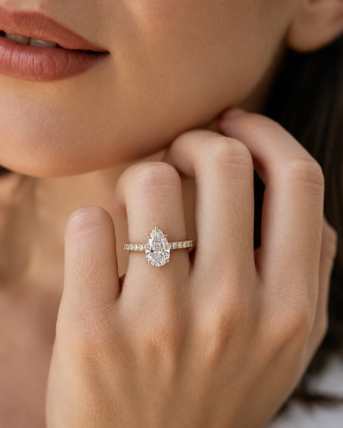 color_10K_YG, color_14K_YG &&Pear moissanite engagement ring with a sparkling pave band front view.
