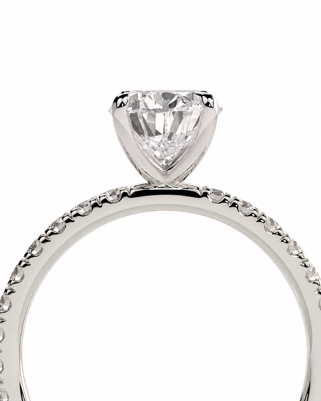 color_925_SIL,color_935_ARG,color_10K_WG, color_14K_WG &&A close-up of a silver-toned solitaire engagement ring featuring a triangular-cut clear gemstone in a prong setting, with a textured band and small pave accents, shown on a plain white background.