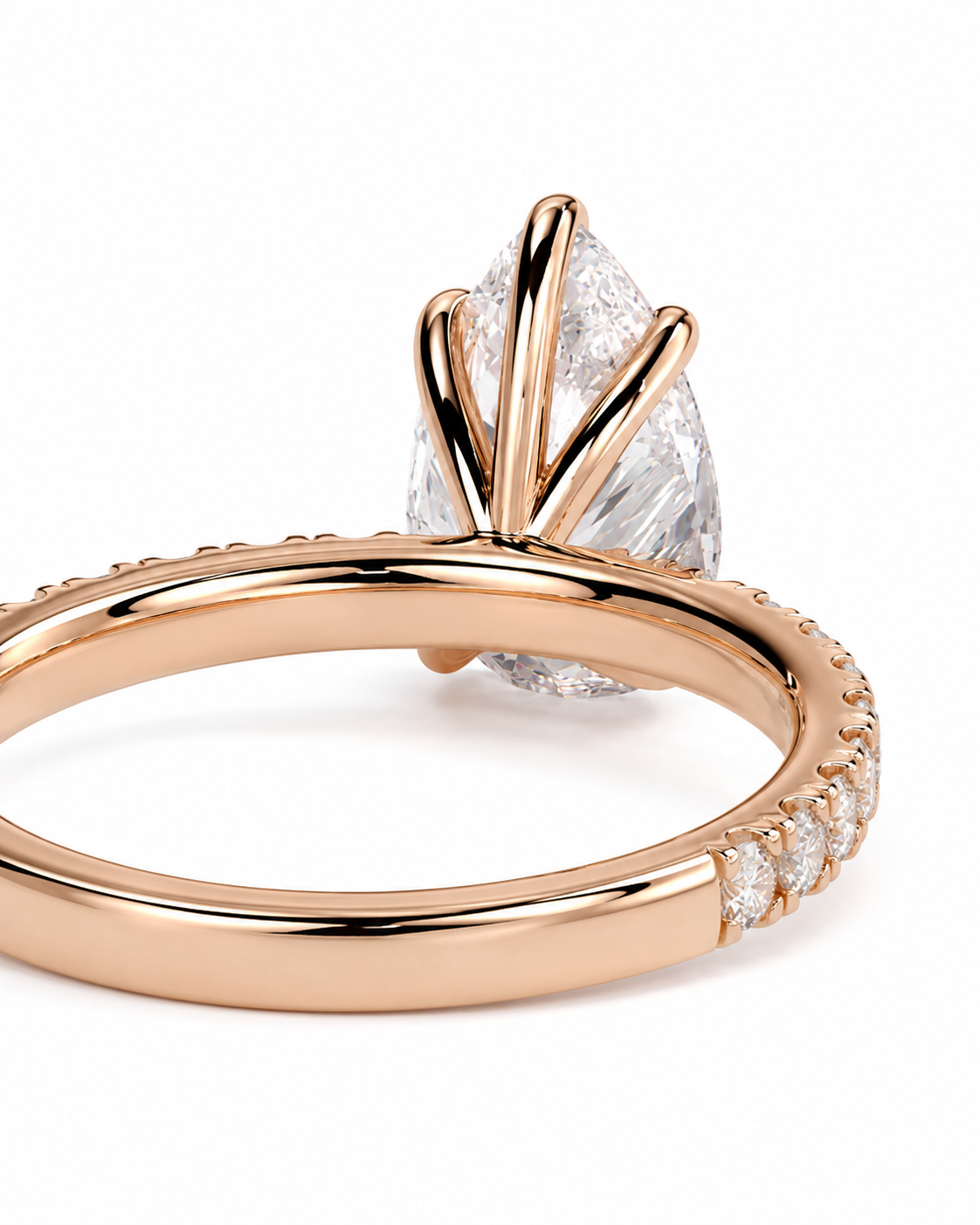 color_10K_RG, color_14K_RG &&Rose gold ring with a pear-cut clear center stone and small accent stones along the band, shown on a white background.